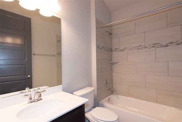 full bathroom featuring vanity, tiled shower / bath combo, and toilet