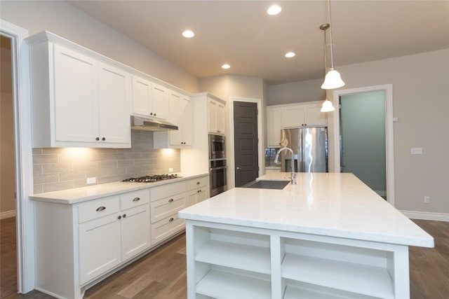 kitchen with pendant lighting, sink, white cabinetry, and stainless steel appliances