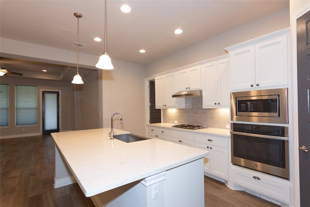 kitchen with pendant lighting, an island with sink, appliances with stainless steel finishes, and sink