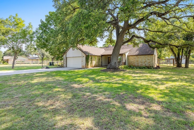 view of front of house featuring a garage and a front yard