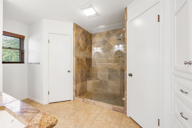 bathroom featuring a tile shower and tile patterned floors