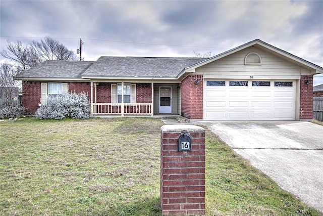 ranch-style house featuring a garage, covered porch, and a front lawn