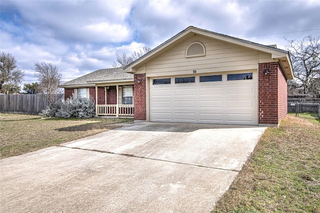 ranch-style house featuring a porch, a garage, and a front yard