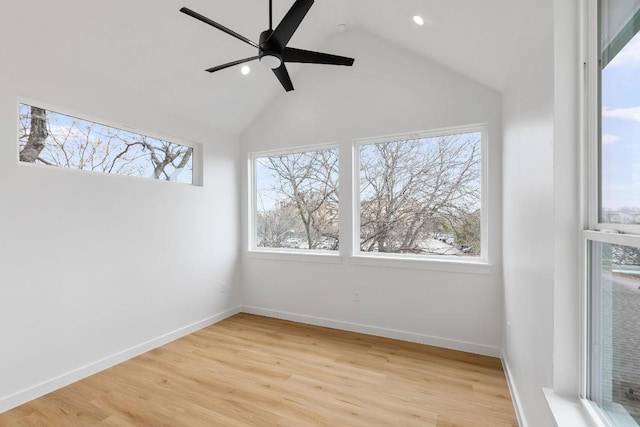 empty room featuring high vaulted ceiling, ceiling fan, and light hardwood / wood-style flooring