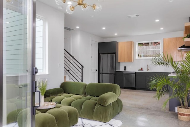 living room featuring sink and a notable chandelier