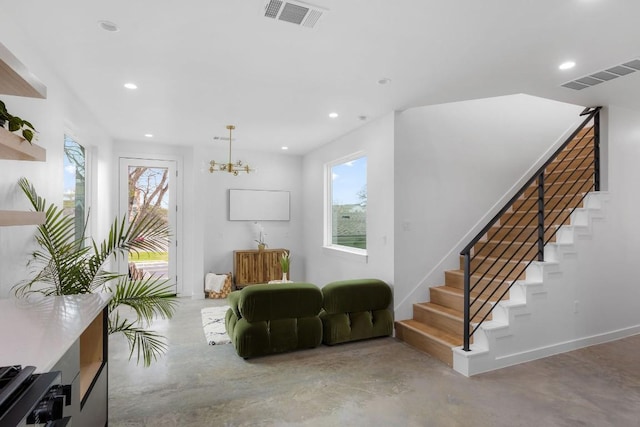 sitting room with a wealth of natural light and a chandelier