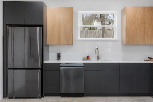 kitchen featuring stainless steel refrigerator, sink, and decorative backsplash