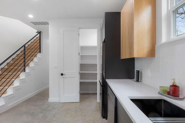 kitchen with tasteful backsplash and sink