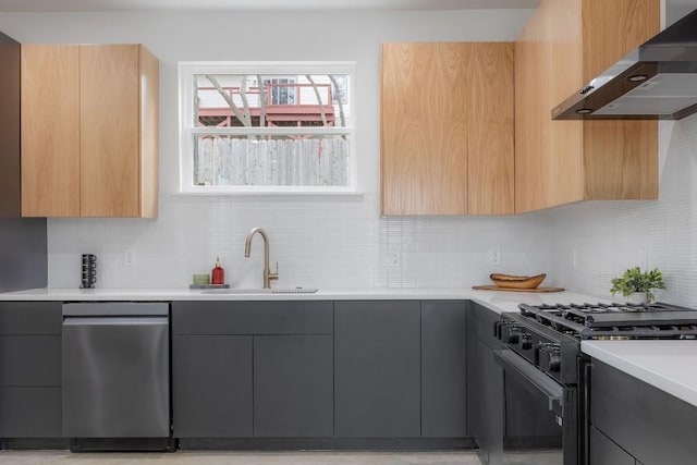 kitchen featuring sink, light brown cabinets, black gas range, decorative backsplash, and exhaust hood