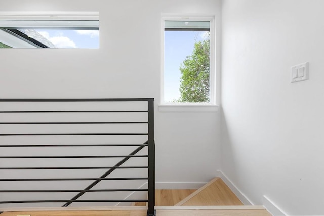 stairs with hardwood / wood-style floors