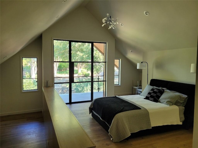 bedroom with dark wood-type flooring, an inviting chandelier, and vaulted ceiling