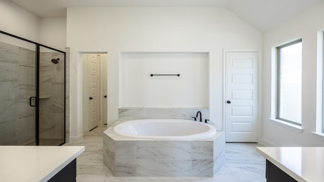 bathroom featuring marble finish floor, a garden tub, a closet, vaulted ceiling, and vanity