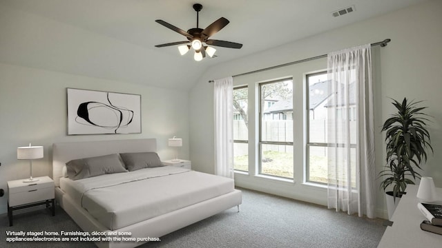 bedroom featuring visible vents, vaulted ceiling, carpet flooring, and ceiling fan