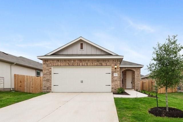 view of front facade with a garage and a front lawn