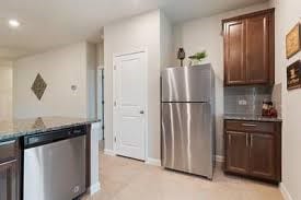 kitchen featuring stainless steel appliances, recessed lighting, decorative backsplash, stone countertops, and baseboards