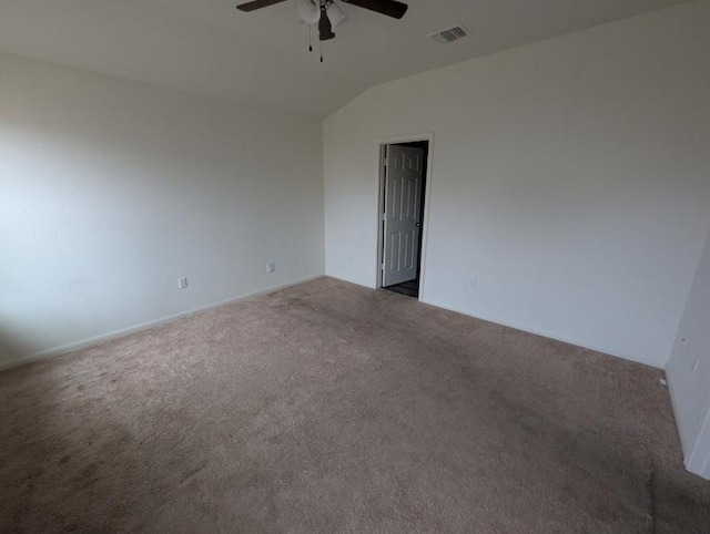 spare room featuring carpet, lofted ceiling, and ceiling fan