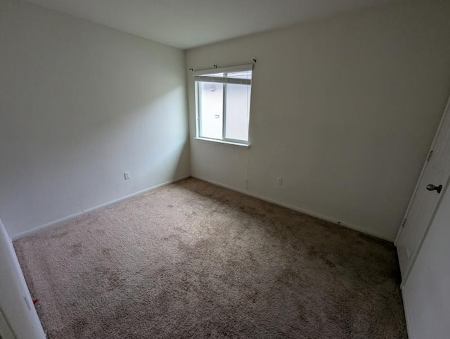 unfurnished room featuring carpet flooring