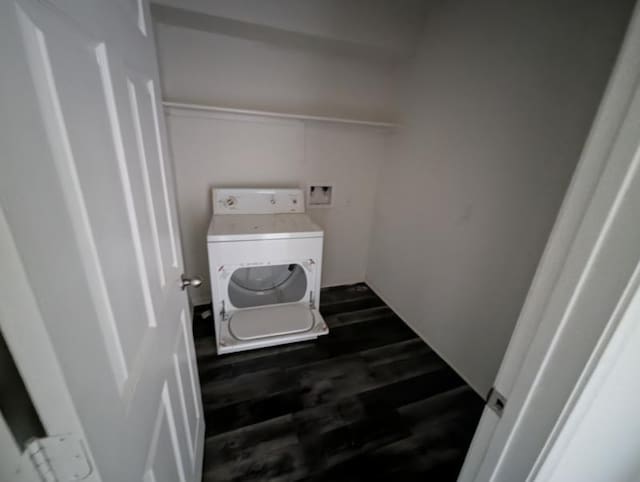 washroom with washer / dryer and dark hardwood / wood-style flooring