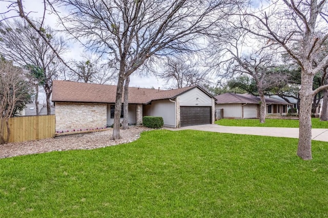 ranch-style house featuring a garage and a front lawn