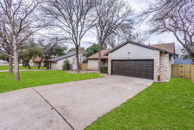 ranch-style house featuring a garage and a front lawn