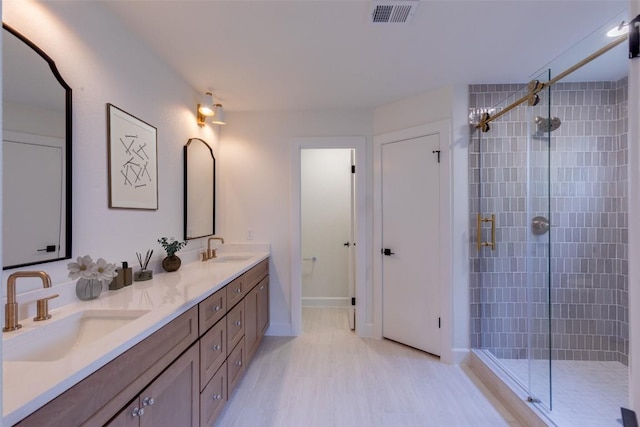 bathroom with walk in shower, vanity, and hardwood / wood-style flooring