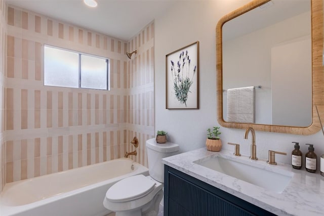 full bathroom featuring vanity, toilet, and tiled shower / bath