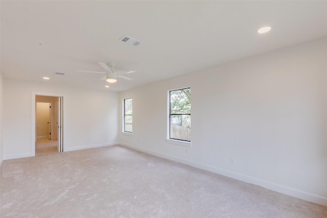 unfurnished room with light carpet and ceiling fan