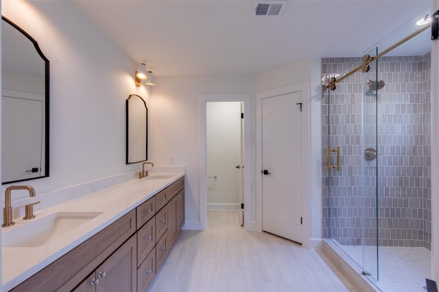 bathroom with vanity and a shower with shower door