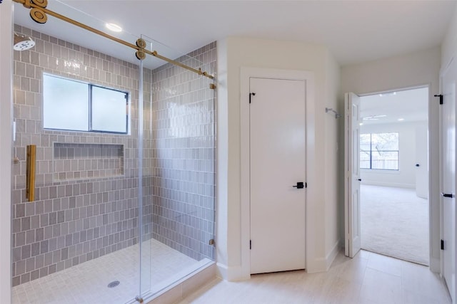 bathroom featuring a shower with shower door and tile patterned floors