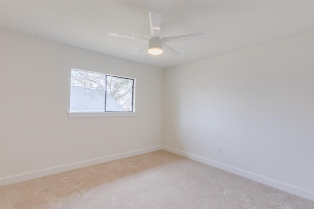 empty room with ceiling fan and light carpet