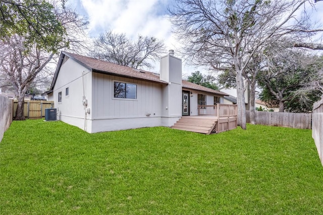 back of house featuring a wooden deck, a yard, and central AC