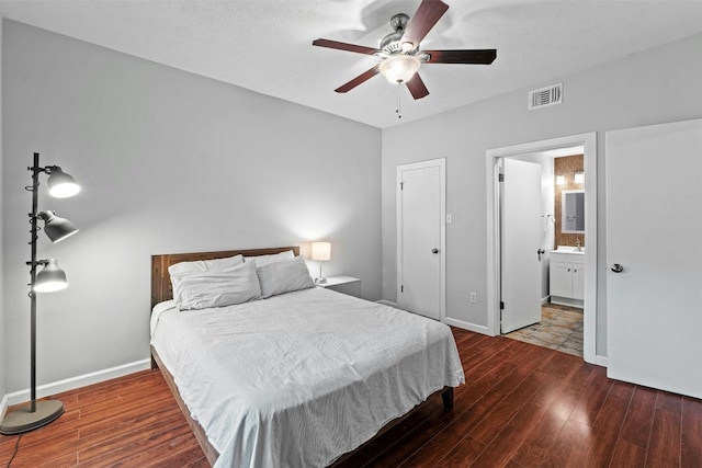 bedroom with hardwood / wood-style flooring, ceiling fan, and ensuite bath