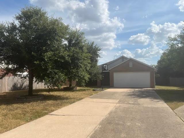 view of front of house with a garage and a front yard