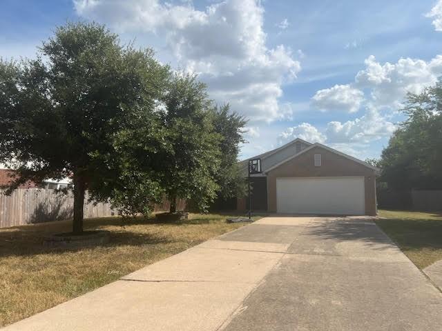 exterior space featuring a garage and a front yard