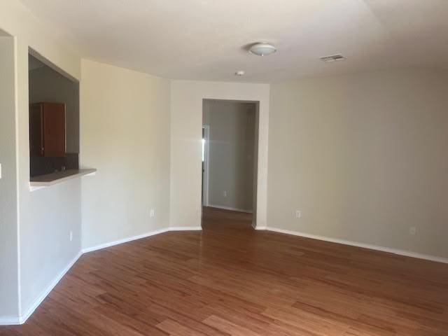 spare room with dark hardwood / wood-style flooring