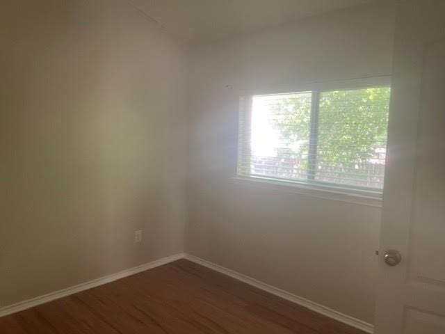 unfurnished room featuring dark hardwood / wood-style floors