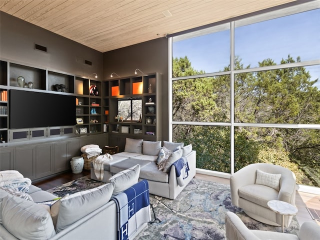 interior space featuring wood ceiling, a wall of windows, and hardwood / wood-style flooring