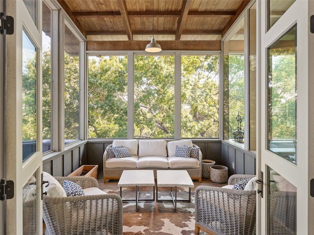 sunroom / solarium featuring beam ceiling, wood ceiling, and a healthy amount of sunlight