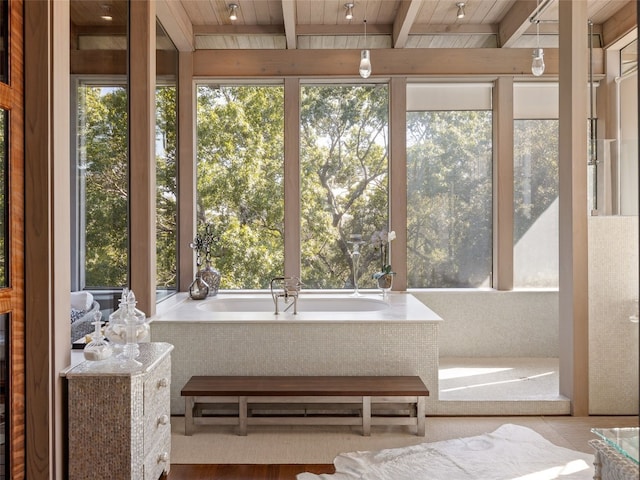 unfurnished sunroom with beamed ceiling and wooden ceiling