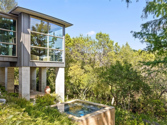 exterior space with an in ground hot tub and a patio