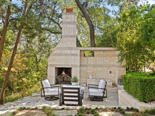 view of patio featuring an outdoor stone fireplace