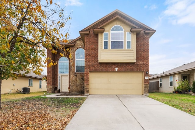 front of property featuring a garage, central AC, and a front yard