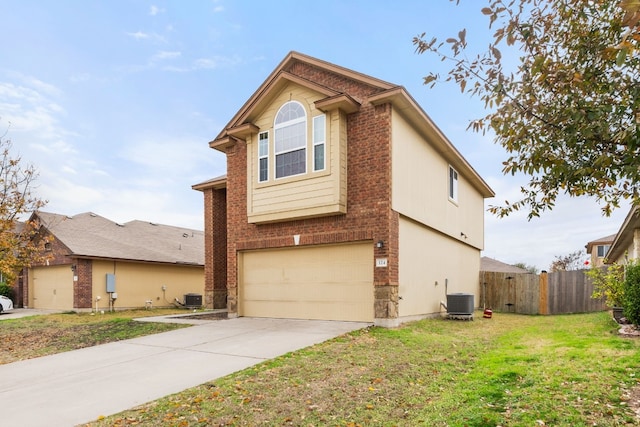 view of front of property with a garage, a front yard, and central air condition unit