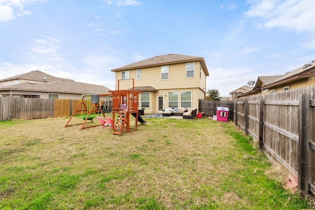 rear view of house with a yard, an outdoor hangout area, and a playground