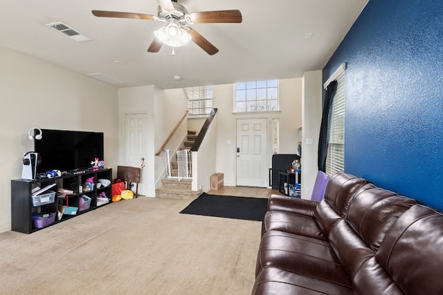 living room featuring ceiling fan and light colored carpet