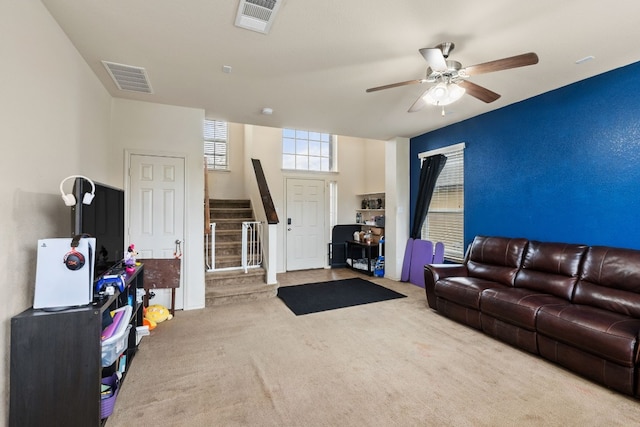 living room with light carpet and ceiling fan