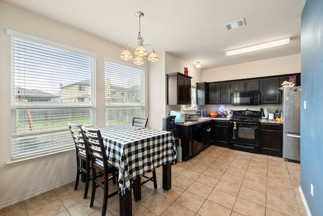 kitchen with light tile patterned flooring, hanging light fixtures, a notable chandelier, black appliances, and dark brown cabinets