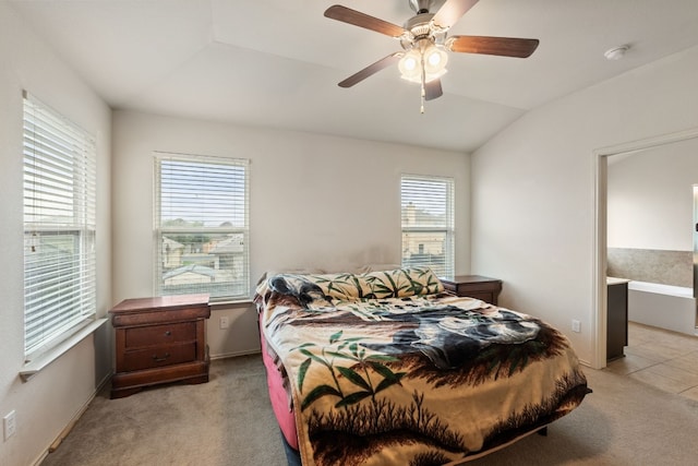 bedroom featuring vaulted ceiling, light colored carpet, and ceiling fan