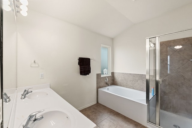 bathroom with lofted ceiling, shower with separate bathtub, tile patterned flooring, and sink