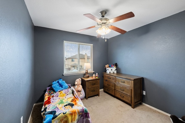 bedroom featuring ceiling fan and light carpet